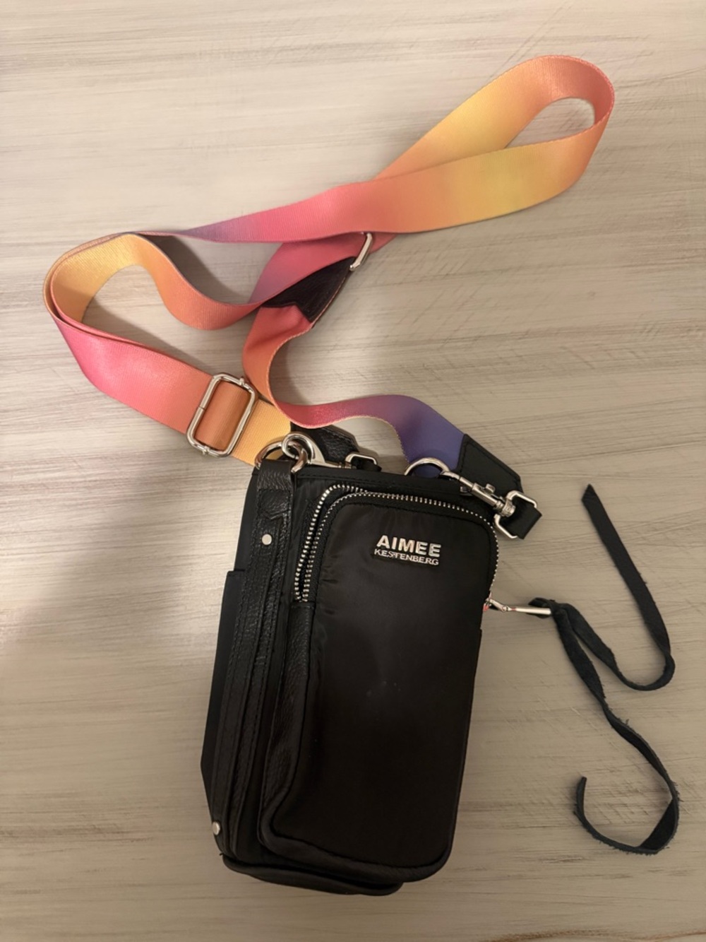 Aimee Kestenberg Black Bottle Holder Crossbody with Rainbow Strap Accent